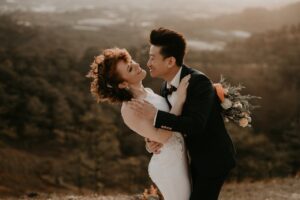 A joyful couple embracing and posing for a pre-wedding photoshoot